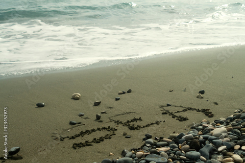 Word Sea written on beach