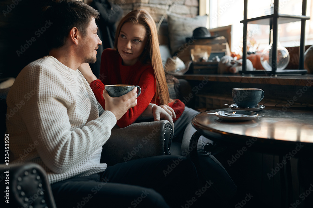 young happy man is talking with his girlfriend, making up plans, future ideas, conversation, meeting, close atmosphere in the cafe. young happy man is talking with his girlfriend, making up plans, future ideas, conversation, meeting, close atmosphere in the cafe.