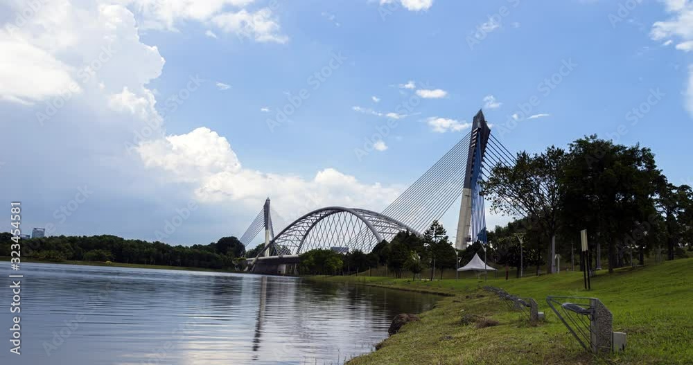 Panorama time lapse from English Garden to the Seri Saujana Bridge in Putrajaya, Malaysia. The Malaysian  Government city 40 km outside of Kuala Lumpur. Wide angle panorama of the cable stayed bridge 