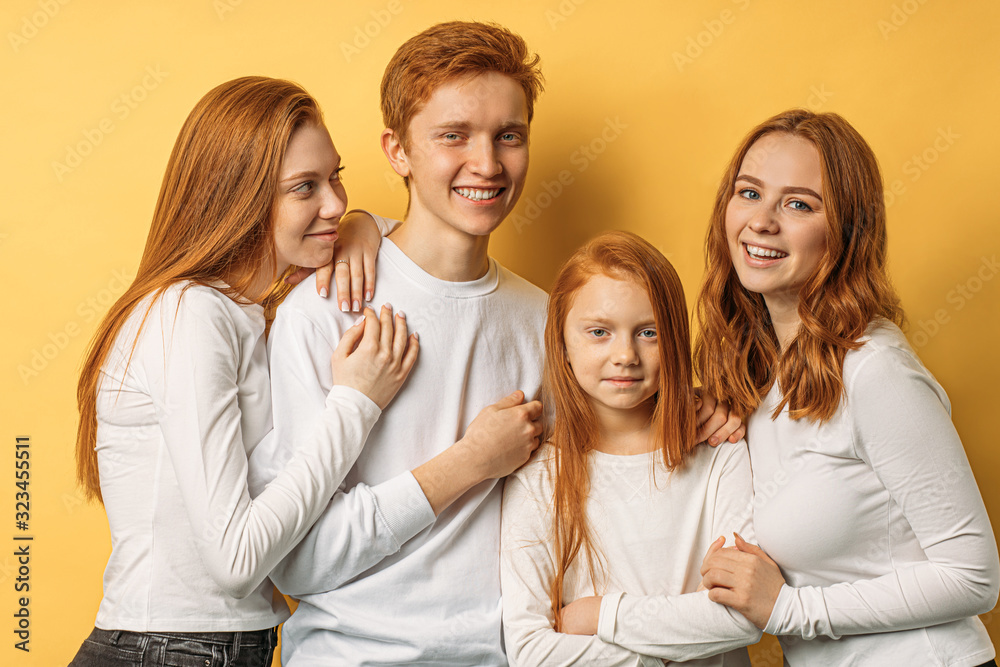 portrait of young and beautiful caucasian red haired brothers and sisters, young lovely people emotionally smile at camera. rareness, unusual people concept portrait of young and beautiful caucasian red haired brothers and sisters, young lovely people emotionally smile at camera. rareness, unusual people concept