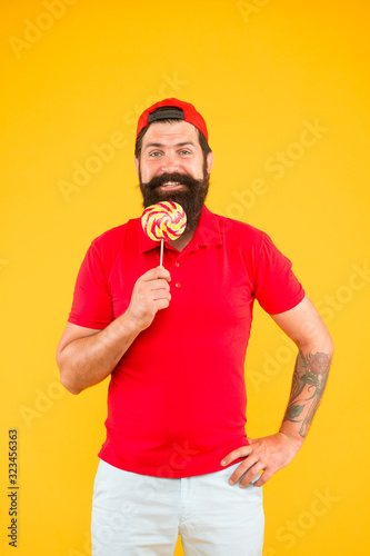 Sweet taste. happy hipster eat lollipop candy. candy shop. Sweet boy. Taste of childhood. Happy eating sweets. Man eat lollipop. Holiday concept. Sugar harmful for health. having fun at summer vibes