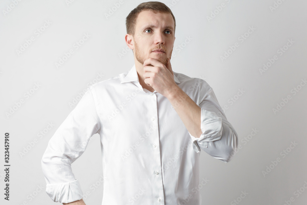 man in a white shirt ponders an idea a businessman man in a white shirt ponders an idea a businessman