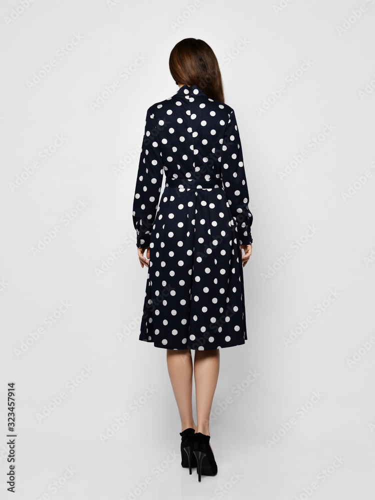 Young beautiful woman posing in new casual fashion spring blue polka dot dress full body Young beautiful woman posing in new casual fashion spring blue polka dot dress full body