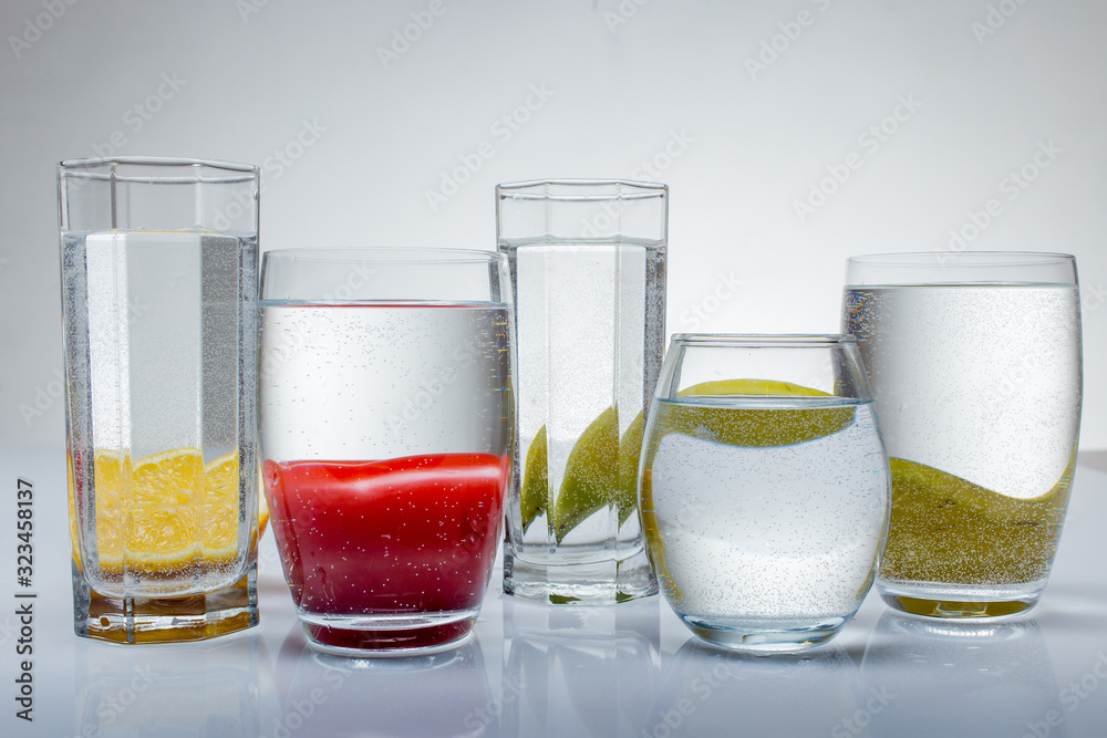 glass of water on white background with fruits glass of water on white background with fruits