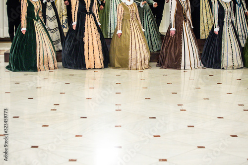 Details with the medieval/Renaissance dresses of women singing in a choir. photo