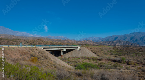 Long shot of Cacheuta Bridge in National route 7 toward the Chilean border in Lujan de Cuyo, Mendoza, Argentina