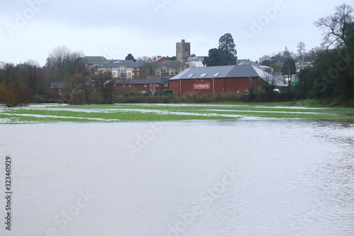 Flooded Axe Valley in East Devon, UK during the storm Dennis. Agricultural fields around river Axe near town of Axminster.