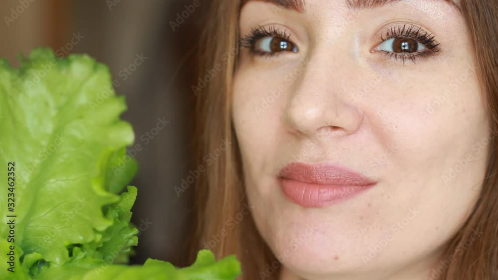 Woman eating green lettuce. Concept of healthy food, vegetarianism, veganism, raw food diet. Woman eating green lettuce. Concept of healthy food, vegetarianism, veganism, raw food diet.