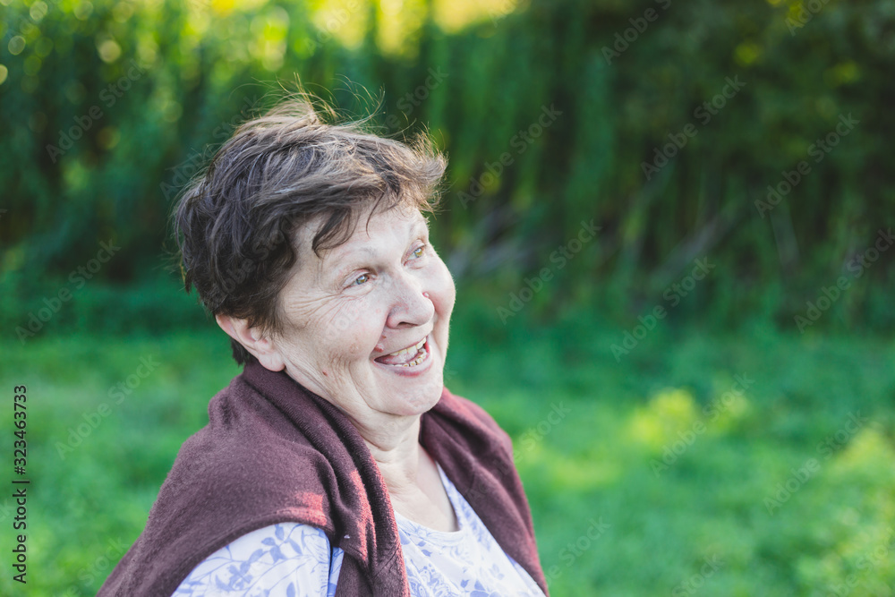 Portrait of senior woman laughing outside Portrait of senior woman laughing outside