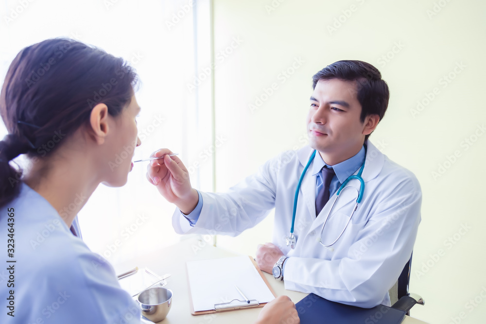 Doctor working at hospital room, using thermometer for checking patient fever because patient just come back from oversea and she risk to get Novel coronavirus 2019. Patient get sick, high temperature Doctor working at hospital room, using thermometer for checking patient fever because patient just come back from oversea and she risk to get Novel coronavirus 2019. Patient get sick, high temperature