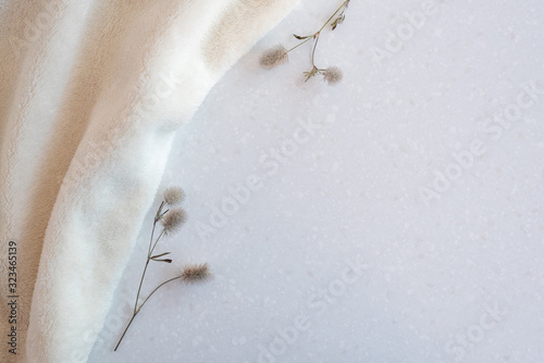 Soft cozy plush fabric with pile lies in beautiful folds on white marble countertop background. Copy space, flat lay.