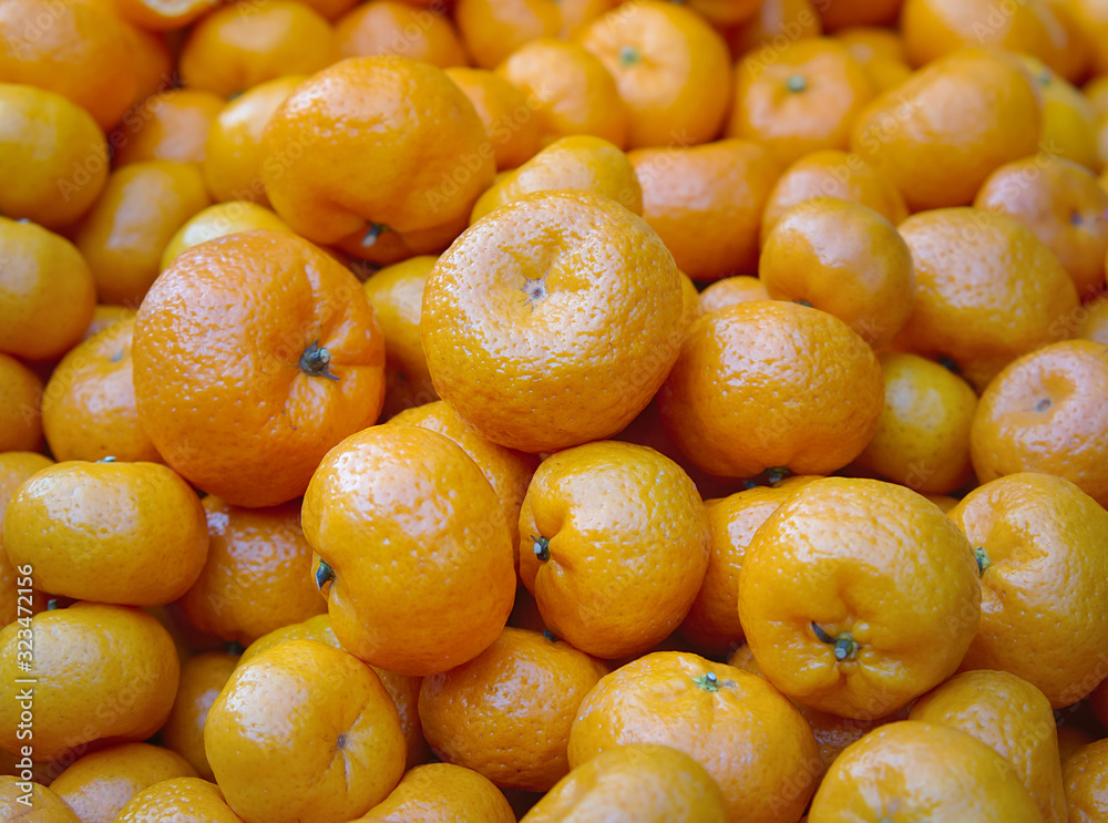 Fresh mandarin oranges ready for sale. Tropical orange fruits on market stall. Fresh mandarin oranges ready for sale. Tropical orange fruits on market stall.