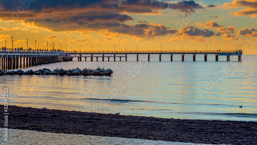 Colorful sunset at a famous marine pier in the Baltic resort city of Palanga,...