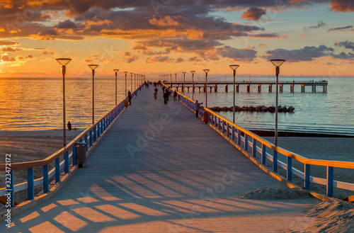 Colorful sunset at a famous marine pier in the Baltic resort city of Palanga,...