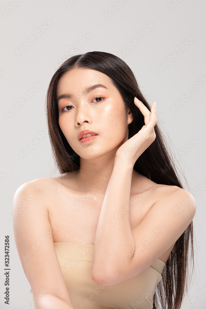 Asian young woman touching soft cheek smile with clean and fresh skin Asian young woman touching soft cheek smile with clean and fresh skin