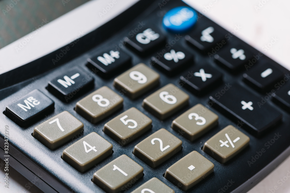 Modern calculator, Business and Finance accounting concept on wooden table Modern calculator, Business and Finance accounting concept on wooden table