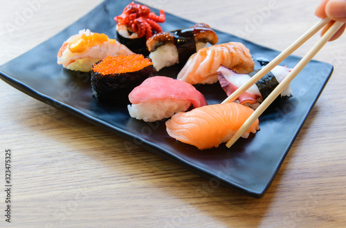 Salmon Sushi with chopstick and Nigiri Sushi set on clay plates photo