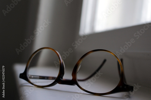 brown glass frames lying upside down on the window sill under natural subdued light