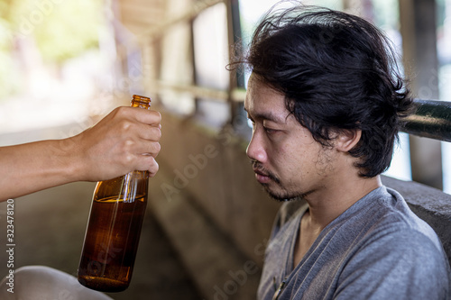 Portrait of a person holding a bottle of liquor and given to another person