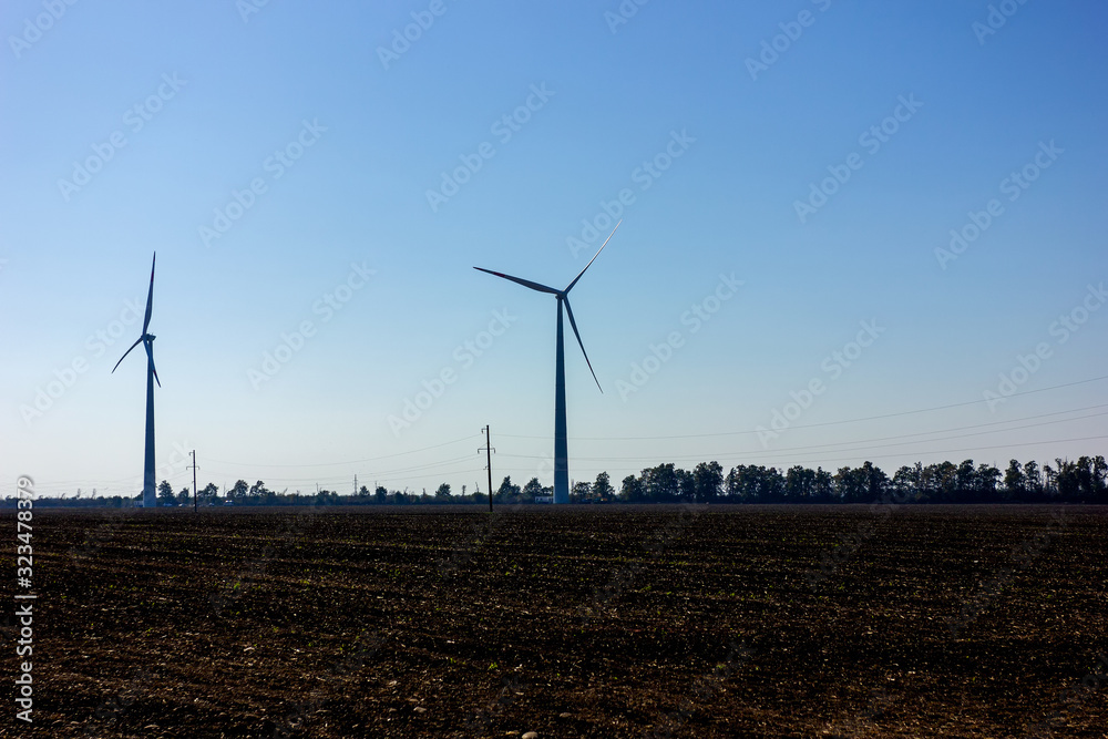 Air turbines that produce electrical energy on a Sunny morning on an autumn day.