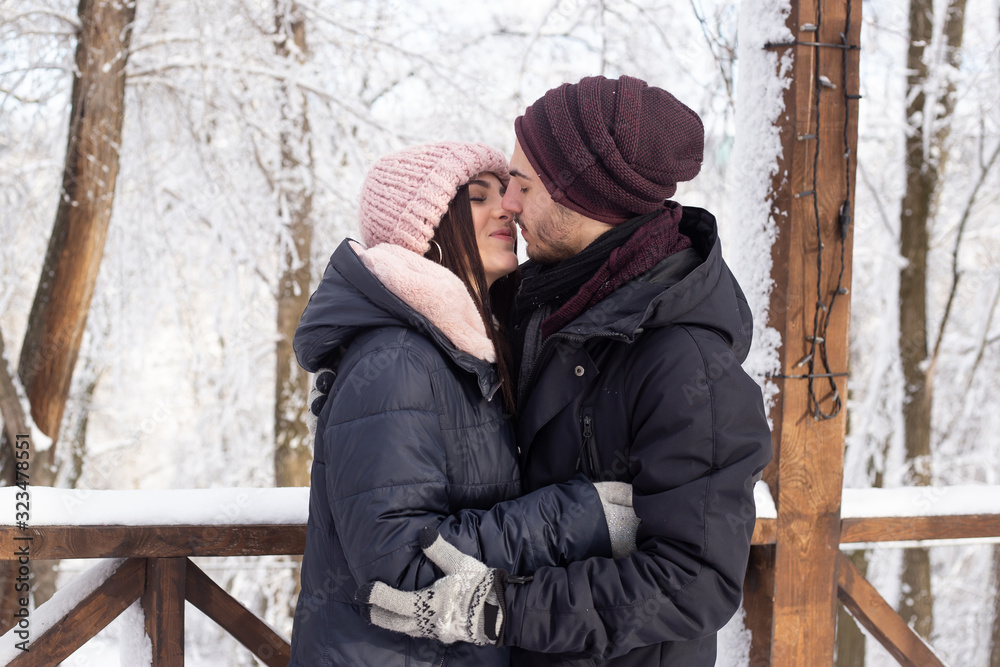 couple kissing on snowy street in winter