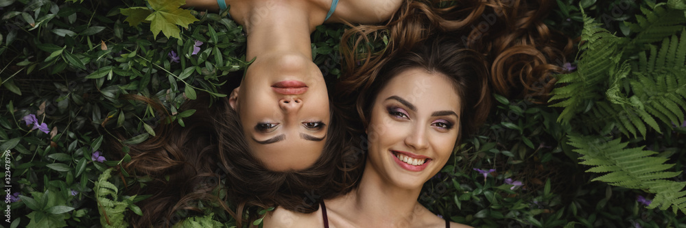 Spring beauty or woman natural cosmetics concept. Fashion portrait photo of two women