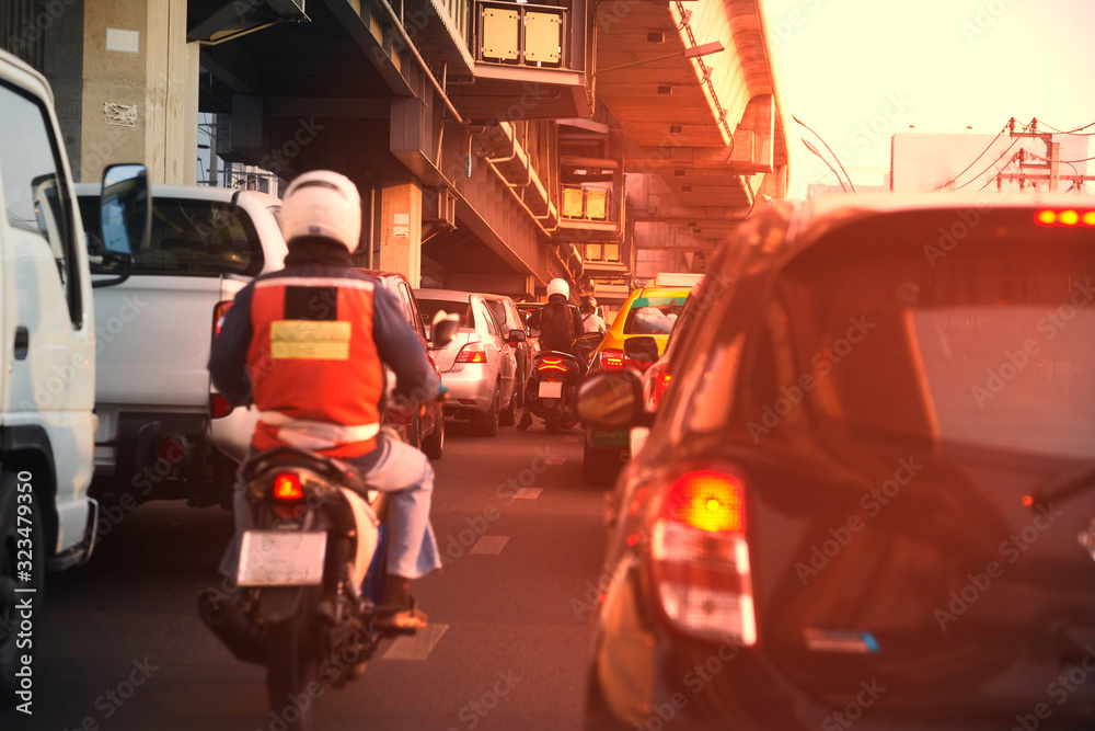 Traffic jam in the morning with sun light include motorcycles cars trucks with overpass