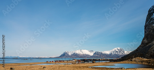 Panorama over Eggum city in the Borgum area in Lofoten, Norway. Blue sky and snow covered mountains in the background. photo