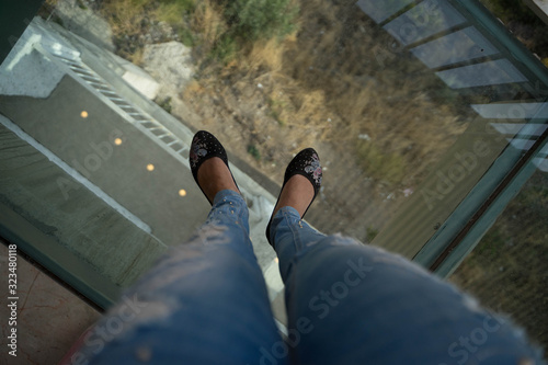 girl stands on a glass floor