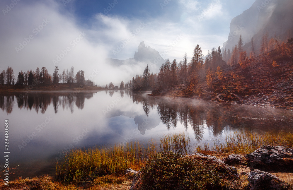 Fototapeta Amazing Scenery of nature with morning fog. Magical Mountain lake Federa in Dolomites Alps glowing sunlit. Wonderful picturesque Scene at Autumn Highlands. Postcard. Awesome Sunny Landscape.