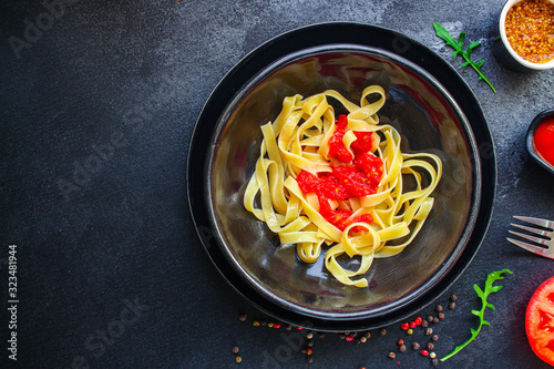 pasta tagliatelle tomato sauce (delicious main course) menu concept. background. top view. copy space