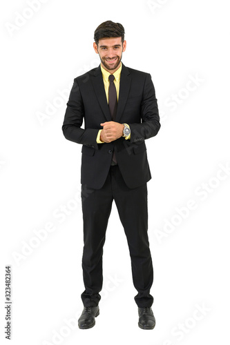 Handsome confident businessman standing and smiling, isolated on white background