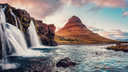 Scenic image of Iceland. Incredible Nature landscape during sunset. Great view on famous Mount Kirkjufell with waterfall on foreground. popular plase for photografers. Best famous travel locations