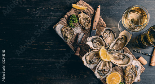 Fresh oysters with lemon ice and white wine. photo