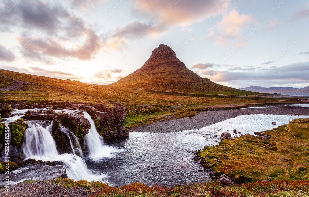 Scenic image of Iceland. Incredible Nature landscape during sunset. Great view on famous Mount Kirkjufell with waterfall on foreground. popular plase for photografers. Best famous travel locations Scenic image of Iceland. Incredible Nature landscape during sunset. Great view on famous Mount Kirkjufell with waterfall on foreground. popular plase for photografers. Best famous travel locations