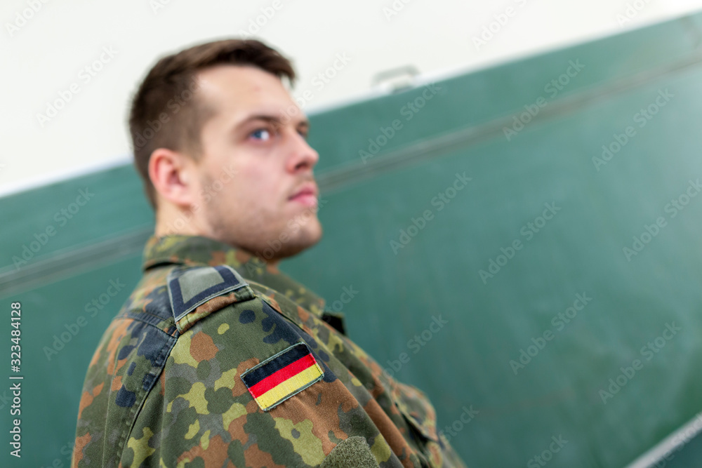 Fototapeta premium German soldier stands in a classroom . German word Bundeswehr, means german army.