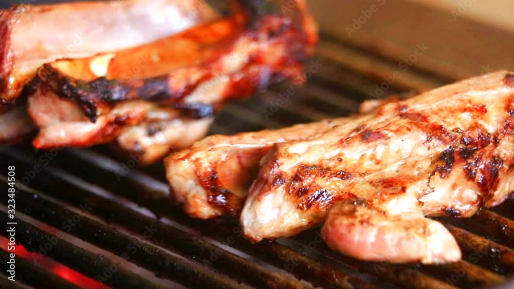 Grilling fresh meat on barbecue close up view Grilling fresh meat on barbecue close up view