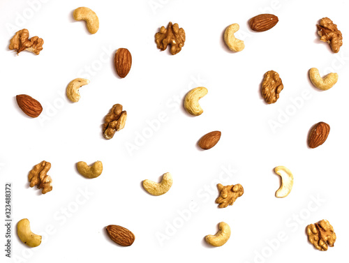 Isolated nuts pattern backdrop. Walnut, cashew, almond and hazelnut on white background. Top view.