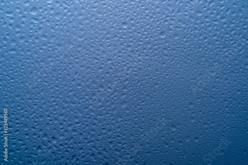  water drops on glass on a blue background
