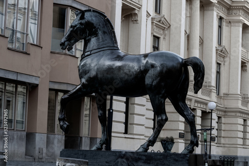 Statue of a horse in the main square in Sweden; Bronze statue depicting a horse in a graceful pose