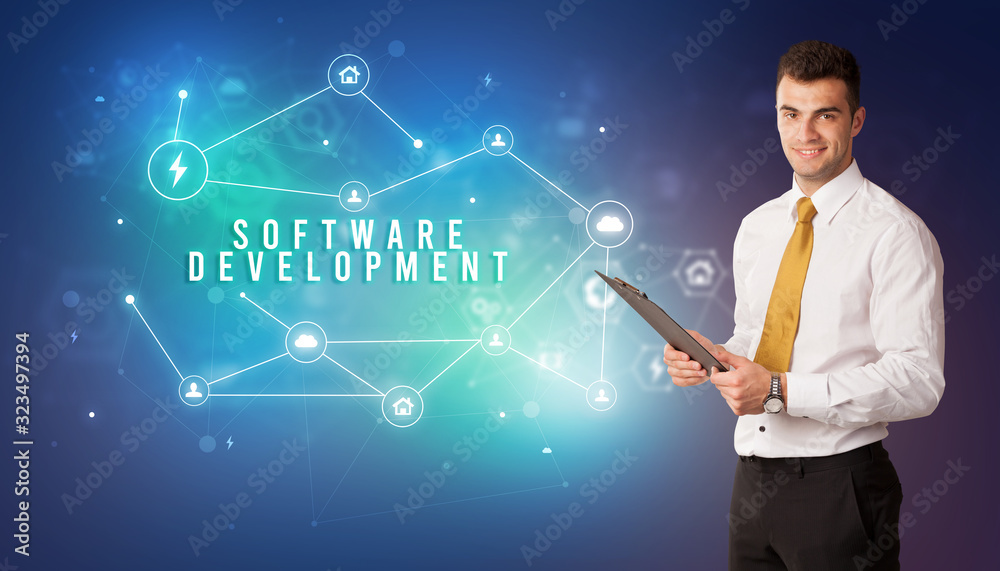 Businessman in front of cloud service icons with SOFTWARE DEVELOPMENT inscription, modern technology concept Businessman in front of cloud service icons with SOFTWARE DEVELOPMENT inscription, modern technology concept