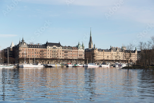 Harbor view with boats and residential houses at the waterfront of the district Östermalm in Stockholm a sunny winter day