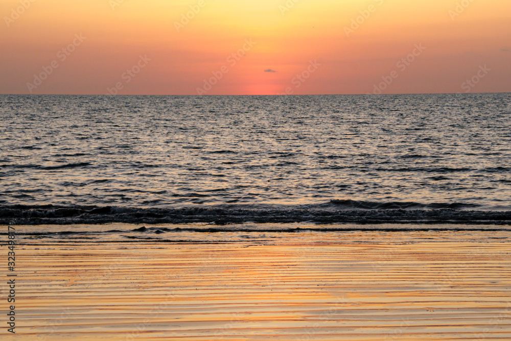 Orange reflections from a sunset on a Panama Beach