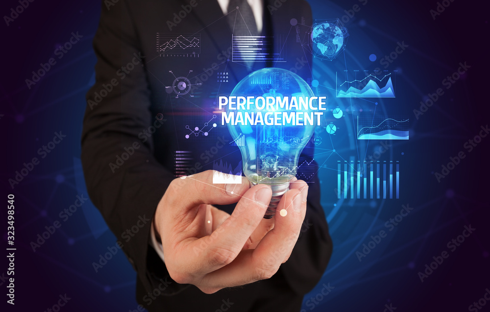 Businessman holding lightbulb with PERFORMANCE MANAGEMENT inscription, Business idea concept Businessman holding lightbulb with PERFORMANCE MANAGEMENT inscription, Business idea concept