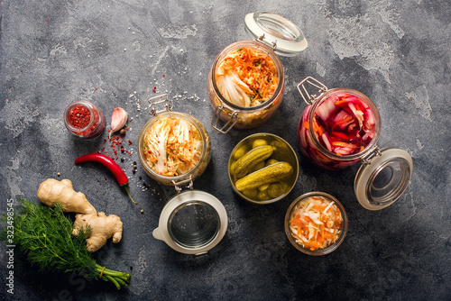 Different fermented vegetables, kimchi, sauerkraut in glas jars, marinated canned food, natural probiotics, healthy eating, prebiotic rich food for digestion, weight loss and immunity boost photo