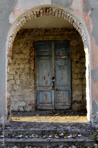 old door in stone wall © Andrii