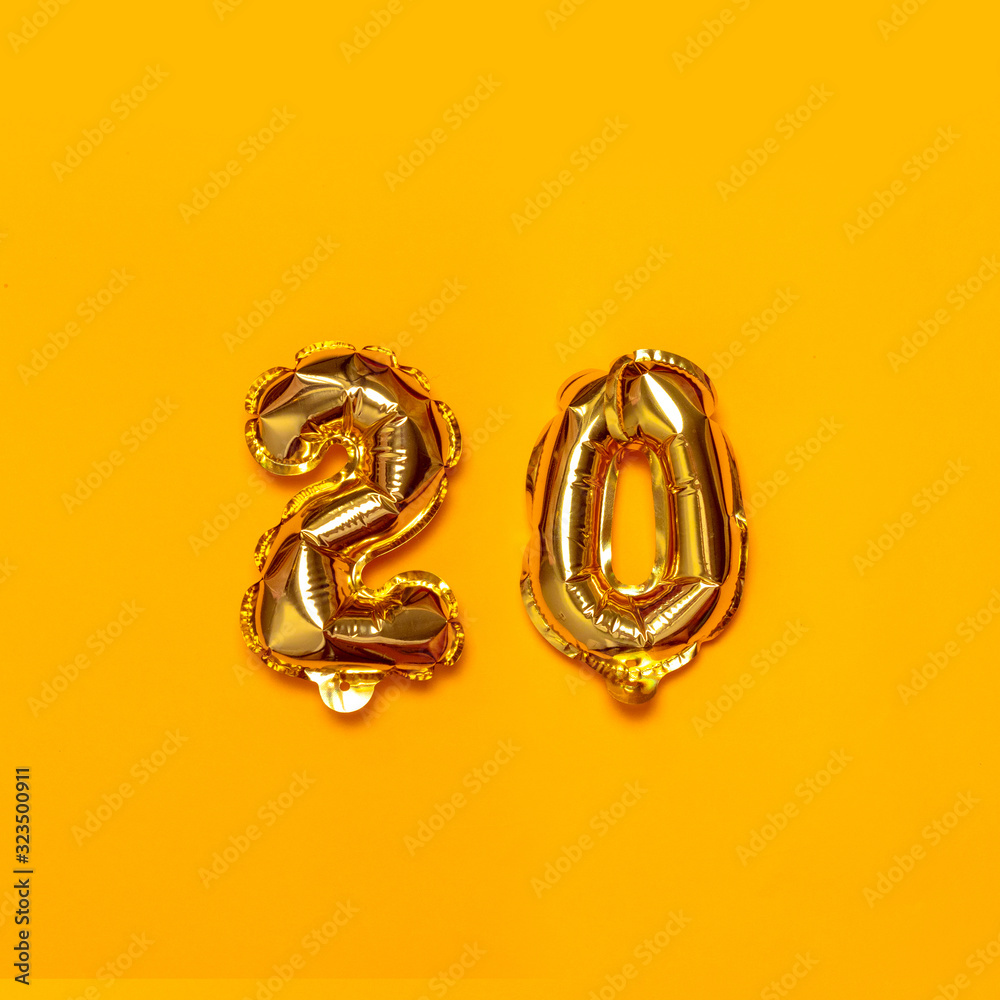 Holiday party decoration helium gold 20 number balloons on a pink background. Congratulation concept. Holiday party decoration helium gold 20 number balloons on a pink background. Congratulation concept.