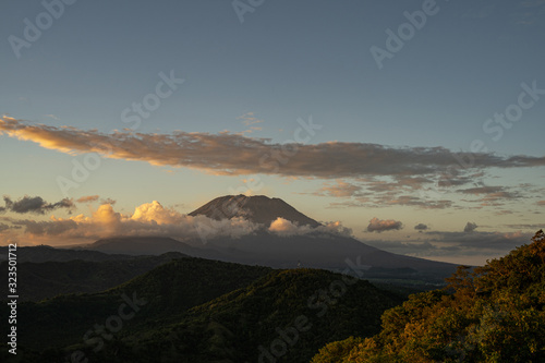 Grassy hills with dormant volcano on background