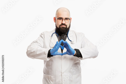 Male doctor in a white coat with a stethoscope and gloves. White background.