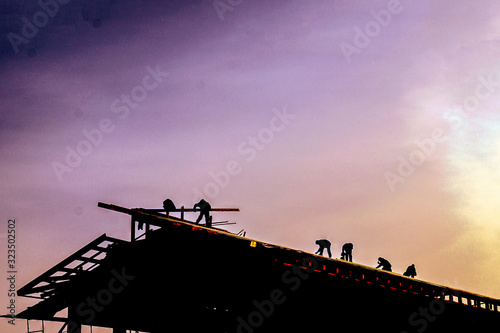 builders make the roof of a large building